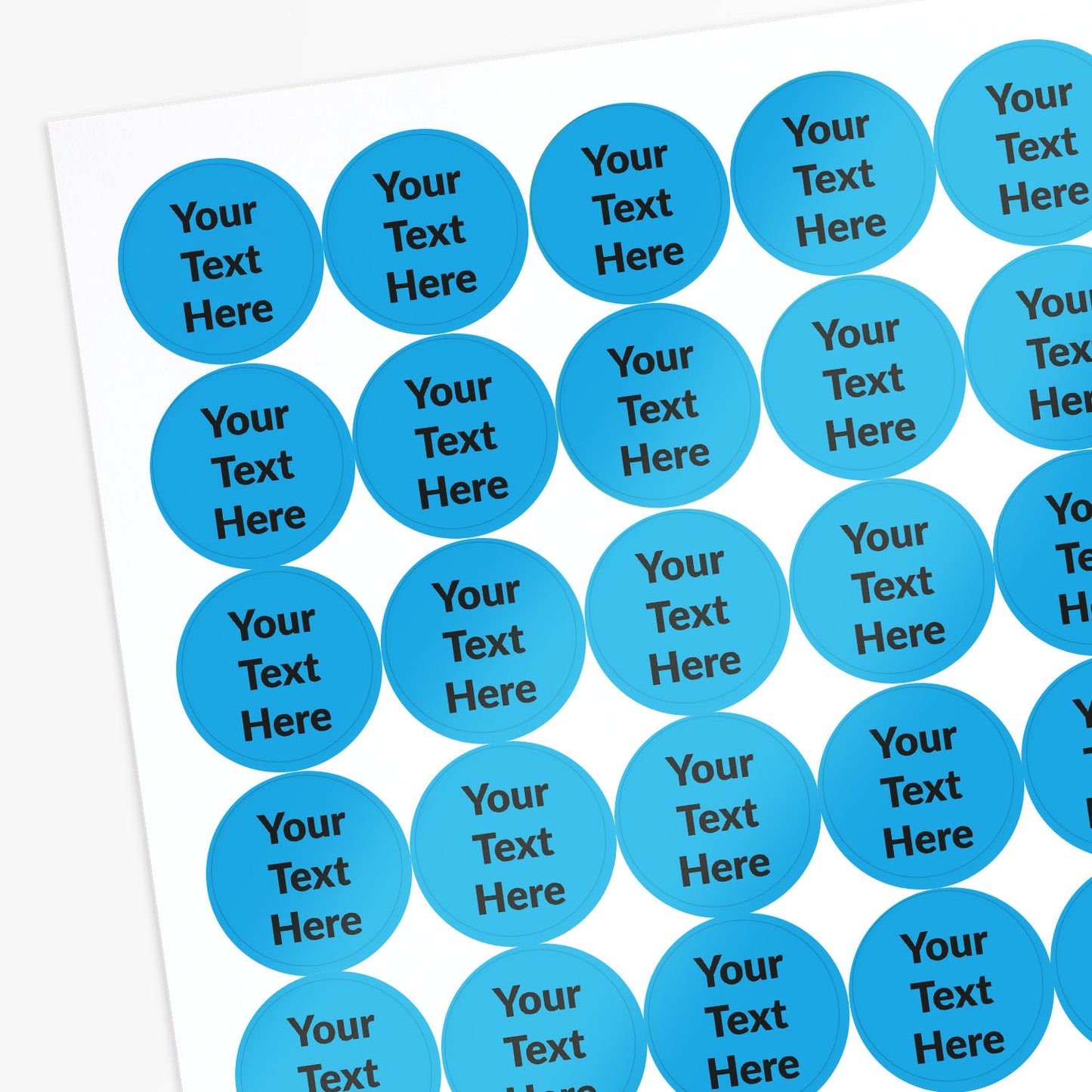 Sheet of blue circular stickers with black text saying 'Your Text Here'