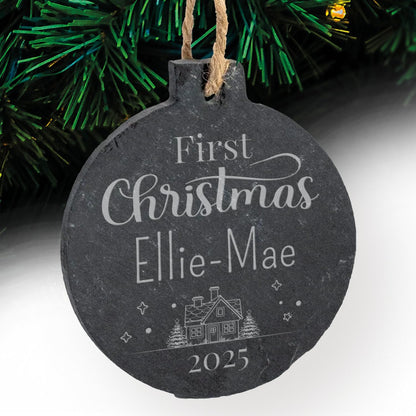 Round slate Christmas bauble with 'First Christmas Ellie-Mae 2025' text against a festive background.