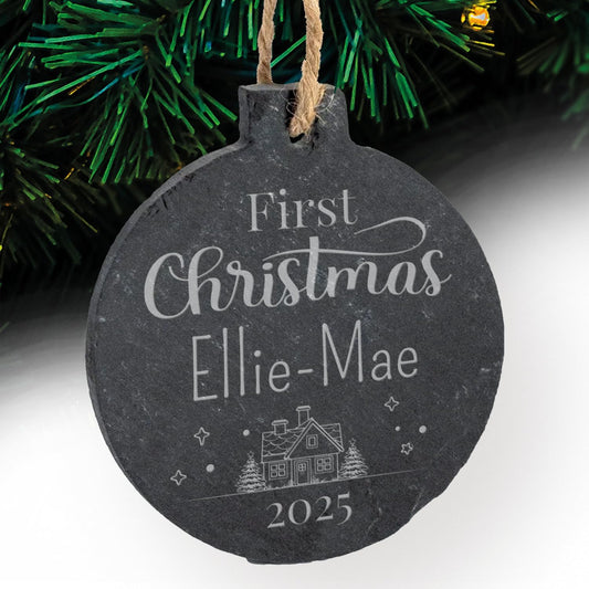 Round slate Christmas bauble with 'First Christmas Ellie-Mae 2025' text against a festive background.