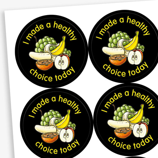 A sheet of circular stickers with a black background. Each sticker features a selection of fruit as a central image including a bunch of grapes, a peeled banana and half an apple and orange. The phrase 'I made a healthy choice today' is written in yellow font around the image.
