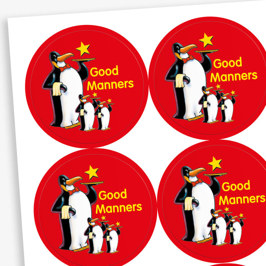 A sheet of red circular reward stickers for children. Each sticker features a group of three cartoon penguins standing together, with a yellow star above them and the phrase 'Good Manners' written in yellow text.