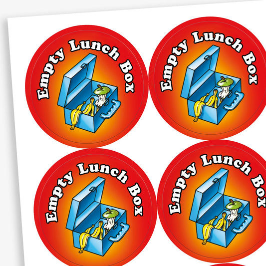 A sheet of circular stickers with a red and orange gradient background featuring an open lunch box containing empty food wrappers, a banana peel, and an apple core. The text around the top reads 'Empty Lunch Box' in bold white letters. These stickers are designed to reward children for finishing their lunch.
