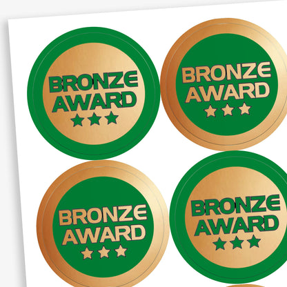 Sheet of 35, 37mm circular stickers with a metallic bronze finish; each sticker features the text 'BRONZE AWARD' above 3 stars.  The sheet has 50% stickers with a bronze base and green text, and 50% a green base with bronze text.