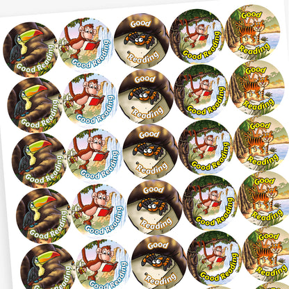 Overview of sheet of circular reward stickers, each featuring a jungle animal and a reading-themed message. Top left: a toucan on a tree branch with the words 'Good Reading'. Top right: a smiling spider on a leaf with the partially covered text 'Good Reading'. Bottom left: a cheerful tiger with the phrase 'Super Reader'. Bottom right: a monkey holding a red book near a waterfall, with the text 'Good Reading'.
