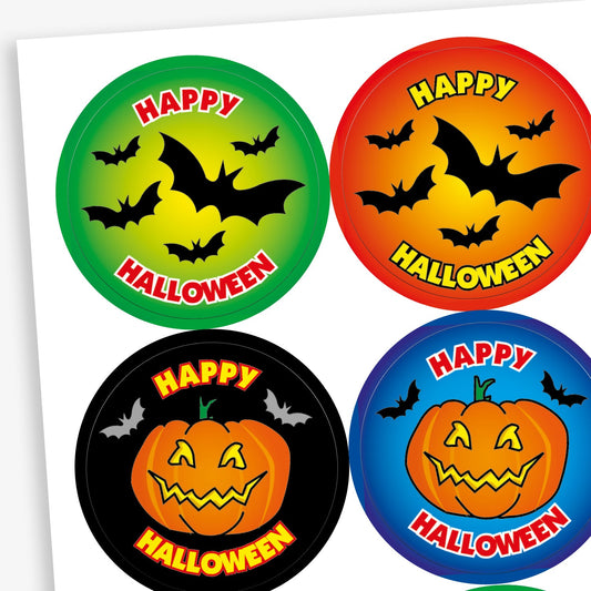 A sheet of circular Halloween-themed reward stickers for children. Top row: two stickers with flying black bats and the phrase 'Happy Halloween'—one with a green and yellow background, the other red and orange. Bottom row: two stickers featuring smiling jack-o'-lantern pumpkins and the same 'Happy Halloween' text—one with a black background, the other with a blue background and bats in the sky.