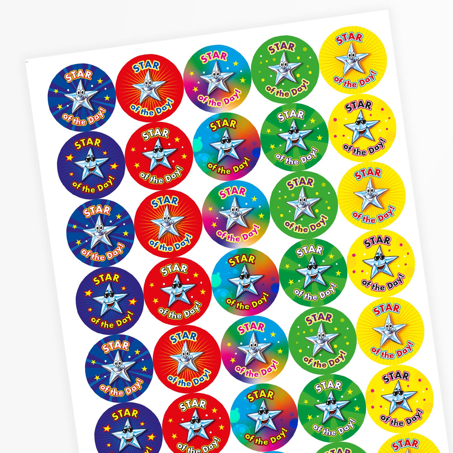 Sheet of round 'Star of the Day' reward stickers featuring smiling cartoon stars with expressive faces. Each sticker has the same message but comes in a variety of vibrant background colours, including green, blue, red, and yellow.