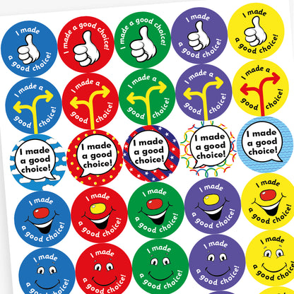 Full sheet of colourful circular reward stickers for children, each with the phrase 'I made a good choice!'. Designs include a blue background with a thumbs-up illustration; a yellow background with a smiling cartoon face; a red background with a yellow direction sign and a green background with a smiling face featuring a red nose.