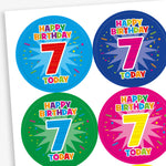 A sheet of circular birthday stickers for children, each with the message 'Happy Birthday 7 Today' in colourful, playful letters. The large number 7 is displayed in the centre of each sticker, with confetti and starburst designs in the background. Sticker colours include red, light blue, yellow, and dark blue.