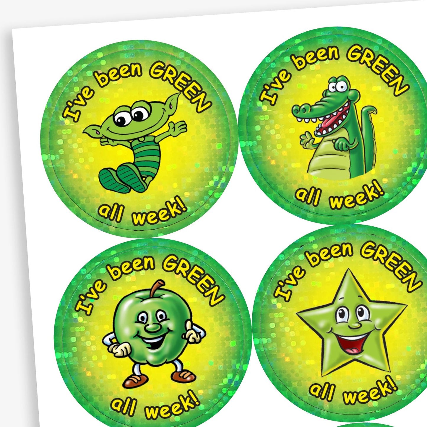 Set of  37mm holographic 'I've been GREEN all week!' reward stickers, featuring cheerful cartoon characters including a green alien, crocodile, apple, and star, each on a vibrant green and yellow background with a sparkly finish.