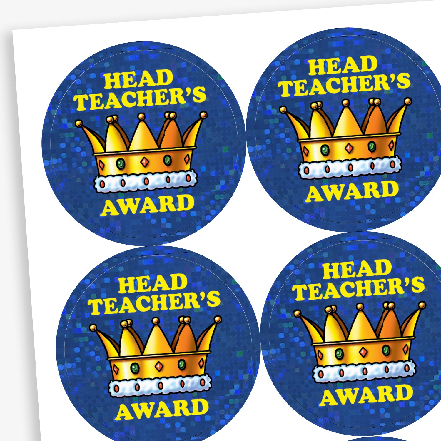 A sheet of circular 'Head Teacher’s Award' stickers with a sparkling, holographic blue background. Each features bold yellow text and a detailed gold crown illustration with red and blue jewels.