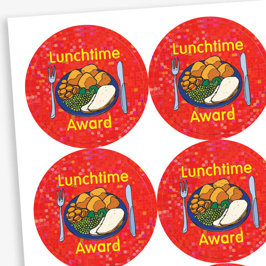 A sheet of 25mm round holographic 'Lunchtime Award' stickers. Each sticker features a vibrant, reflective background with a roast dinner on a plate, with the text 'Lunchtime Award' in bold yellow letters. Ideal for recognising positive behaviour during lunchtime.
