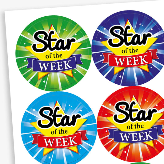 A sheet of circular reward stickers with the phrase 'Star of the Week' in bold text over a yellow star and ribbon design. Each sticker has a different vibrant background, including green, dark blue, light blue, and red, all with starburst effects to create a celebratory look.