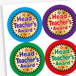 A set of colourful circular stickers with metallic finish, each stating 'Head Teacher's Award' in the centre.