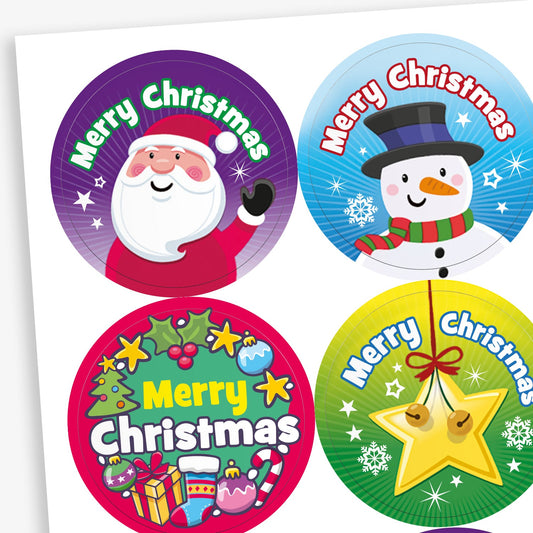 A sheet of circular Christmas-themed stickers all with the phrase 'Merry Christmas'. Designs include: Santa Claus on a purple gradient background; a gold star hanging on a green background; and a smiling snowman with a rainbow scarf and top hat on a snowy blue background