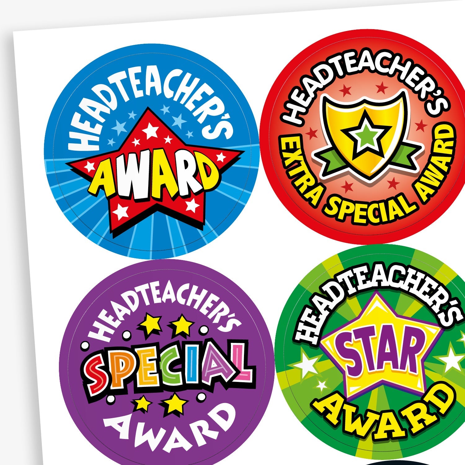 A sheet of colourful circular stickers celebrating pupil achievement with messages from the headteacher. Designs include: 'Headteacher’s Award' with a red star on blue, 'Headteacher’s Extra Special Award' with a gold shield on red, 'Headteacher’s Special Award' in bold text on purple, and 'Headteacher’s Star Award' with a purple star on green. Each sticker is bright and eye-catching.