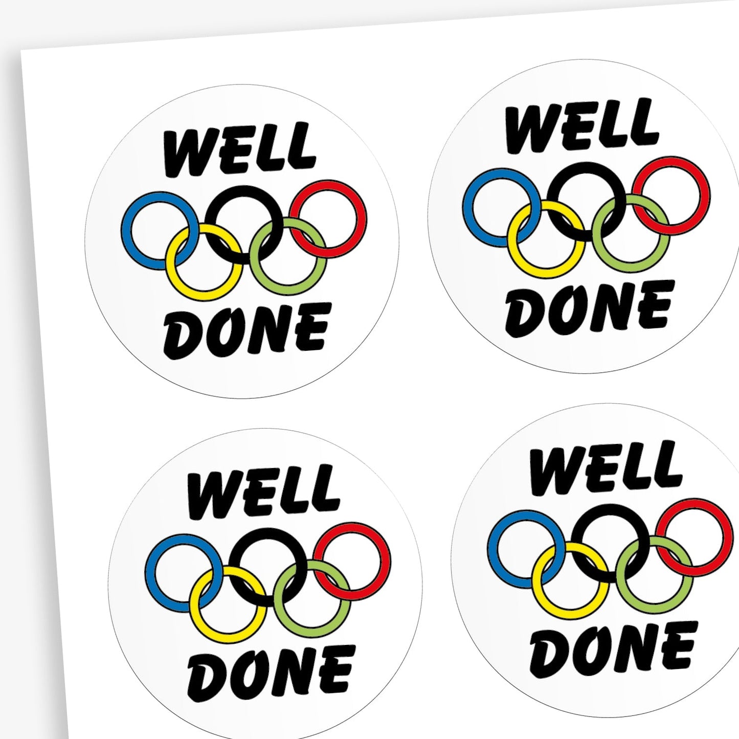 A sheet of white stickers featuring a olympic rings in the centre. Above the image is the word 'WELL' and below the rings 'DONE'.