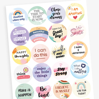 A sheet of round pastel-coloured motivational stickers. Texts include: 'Positive vibes only' with a rainbow, 'The time to start is now', 'Motivate and empower others', and 'I am beautiful, smart, powerful'. Each sticker features soft colours and encouraging typography.