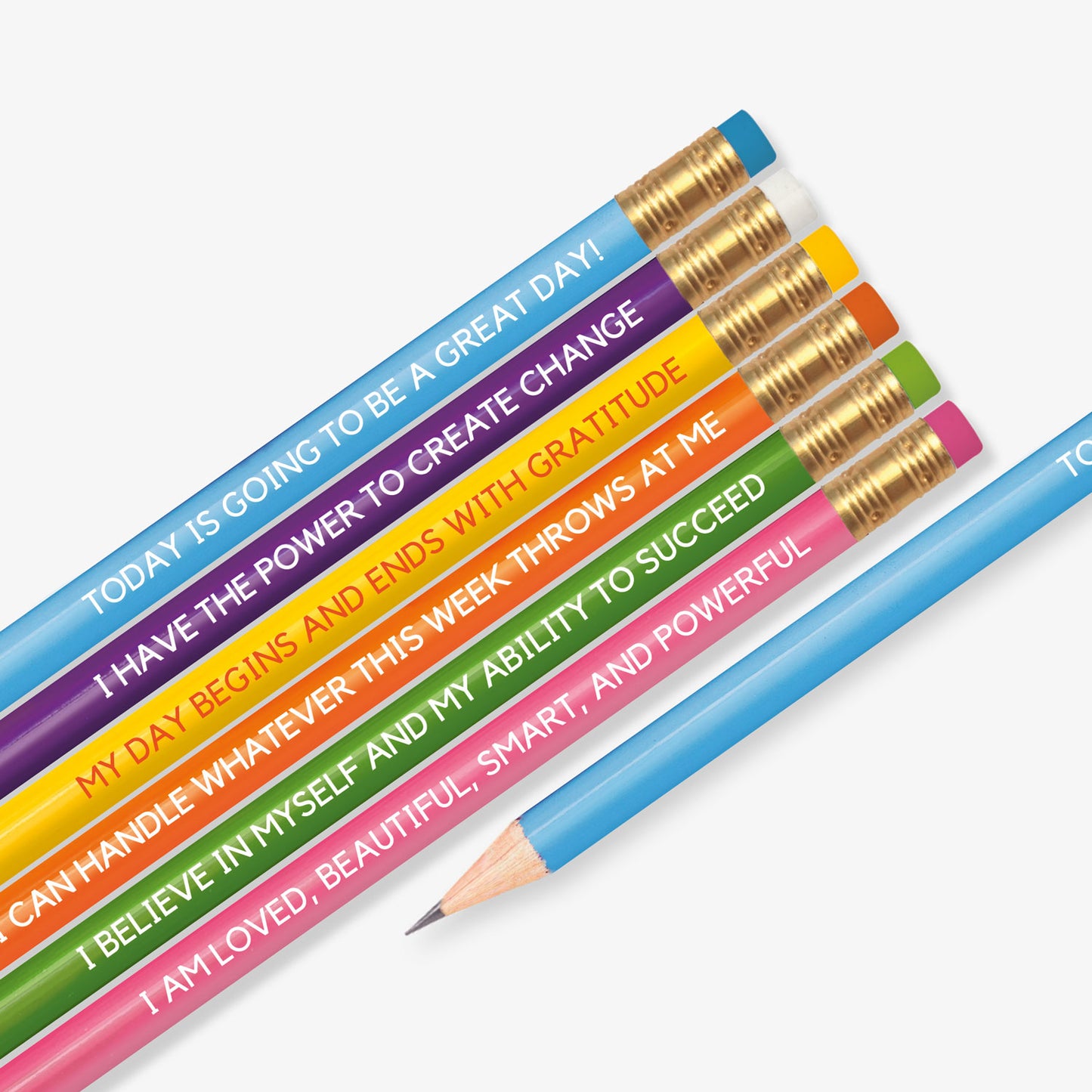 Set of six colourful pencils, each featuring a motivational affirmation. Messages include: 'TODAY IS GOING TO BE A GREAT DAY!', 'I HAVE THE POWER TO CREATE CHANGE', 'MY DAY BEGINS AND ENDS WITH GRATITUDE', 'I CAN HANDLE WHATEVER THIS WEEK THROWS AT ME', 'I BELIEVE IN MYSELF AND MY ABILITY TO SUCCEED', and 'I AM LOVED, BEAUTIFUL, SMART, AND POWERFUL'. Each pencil has a different vibrant colour with a gold ferrule and matching eraser.
