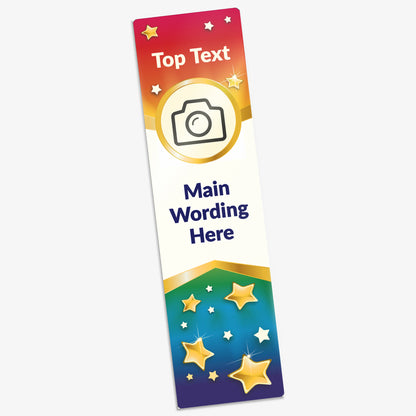 A colourful acrylic bookmark with a gradient background transitioning from red at the top to blue and green at the bottom, decorated with golden and white stars. The top features placeholder text 'Top Text' above a circular photo icon. Below that is the main area for custom text, marked 'Main Wording Here'. The overall design is vibrant and celebratory, suitable for recognition or motivational purposes.