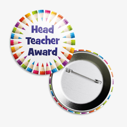 A set of ten 38mm round metal badges featuring a colourful border of pencil illustrations encircling the bold blue text 'Head Teacher Award' on a white background; designed to recognise and reward pupils for outstanding work and behaviour across various subjects.