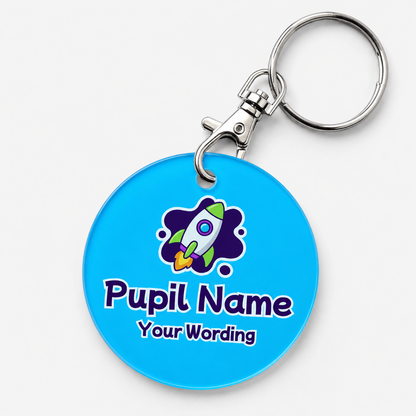 A personalized acrylic bag tag featuring a rocket and example text 'Pupil Name Your Wording'. 