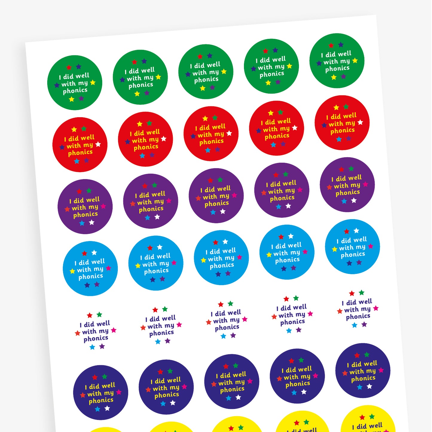 A sheet of colourful circular stickers featuring 'I did well with my phonics' on backgrounds including green, red, purple and cyan.