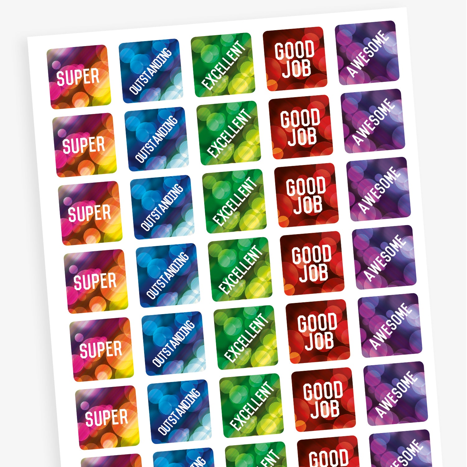 A sheet of square reward stickers with phrases including 'Good Job', 'Awesome', 'Excellent', 'Outstanding' and 'Super'.  The backgrounds are akin to lights through a rainy window and coloured red, purple, green and blue.