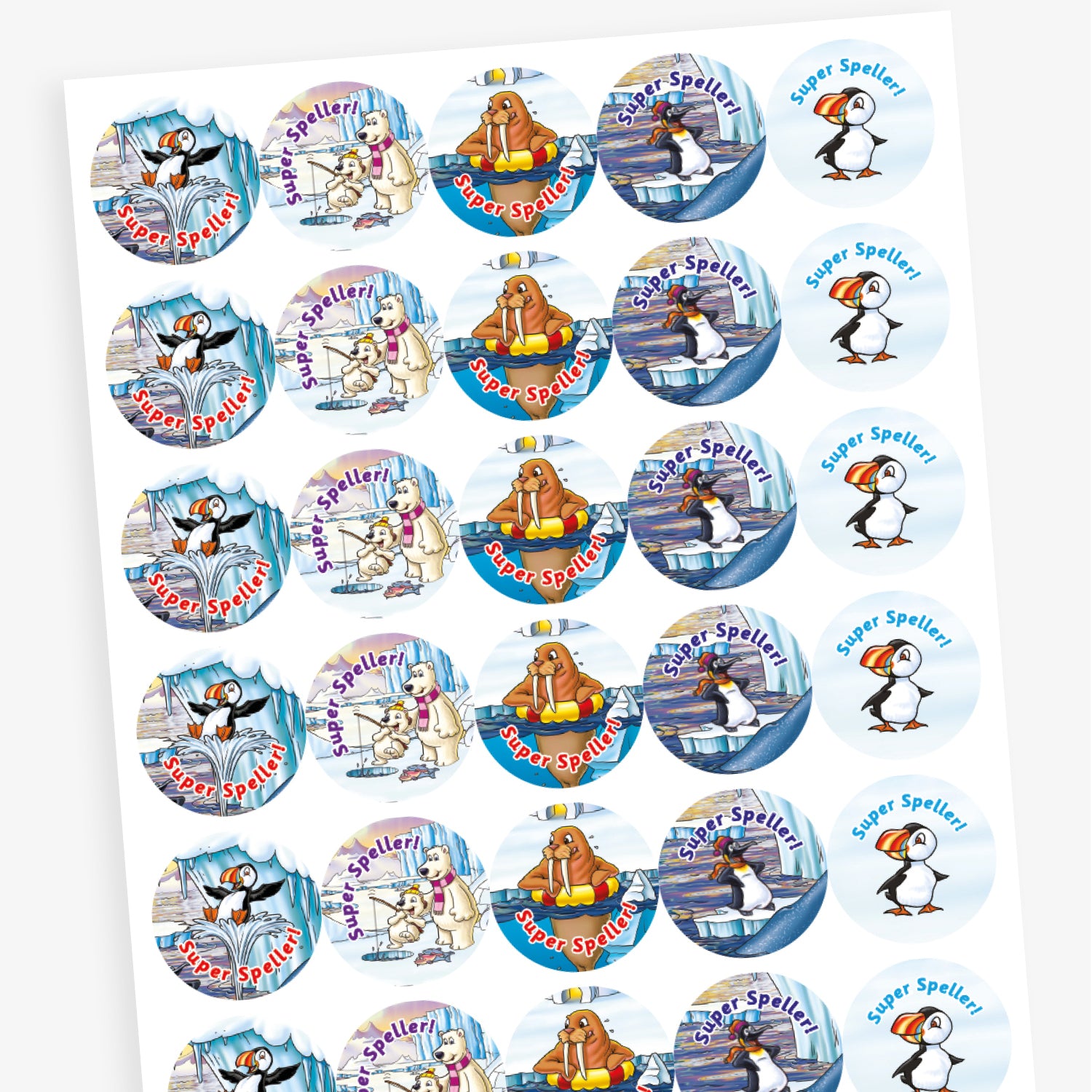 A sheet of circular reward stickers with the phrase 'Super Speller!' in blue or red text. Each sticker features arctic-themed cartoon animals such as puffins, polar bears, and walruses, engaging in playful or reading-related activities against icy, snowy backdrops. The designs are colourful and cheerful, celebrating spelling achievement.
