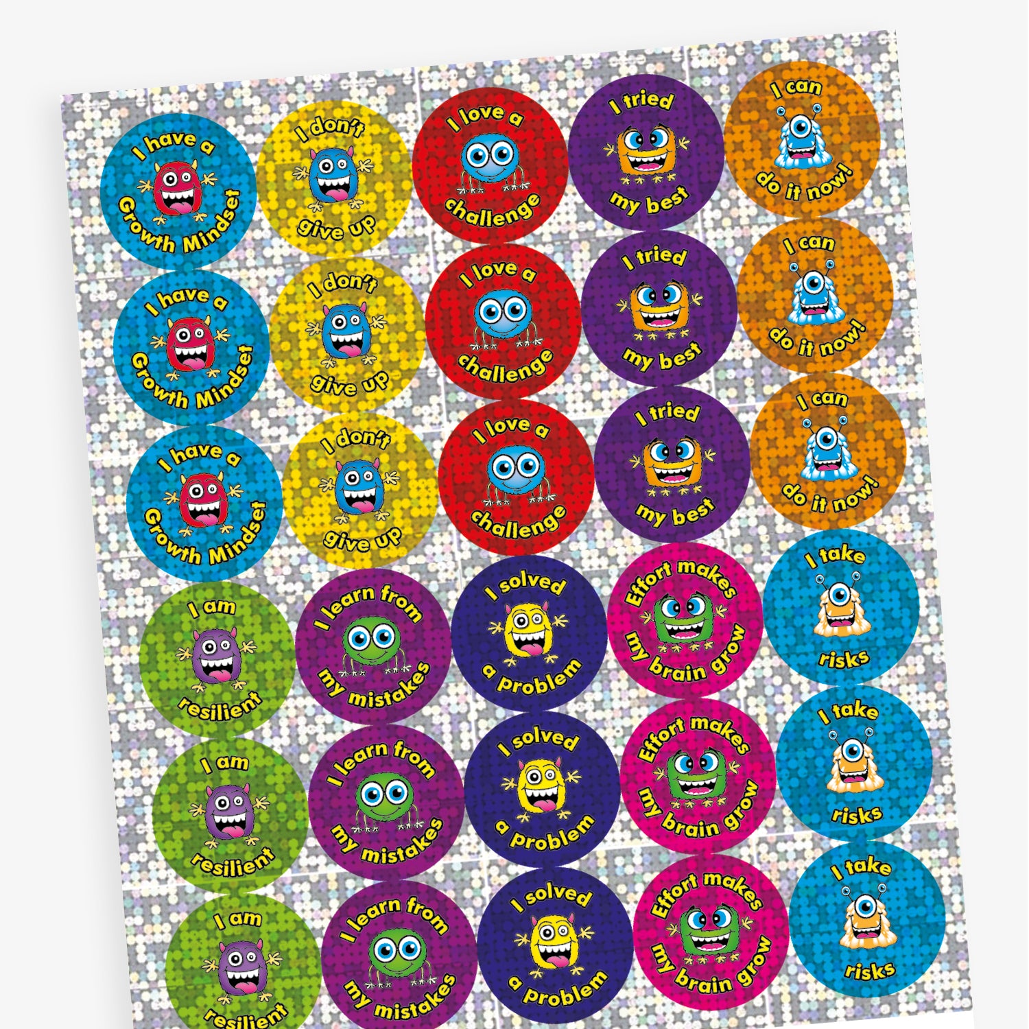 A sheet of shiny, holographic circular stickers featuring colourful cartoon monsters and growth mindset messages. The stickers include phrases such as: 'I have a Growth Mindset', 'I am resilient', 'I learn from my mistakes', 'Effort makes my brain grow', and 'I can do it now!'. Each sticker has a glittery background in vibrant colours like blue, green, pink, orange, and purple.