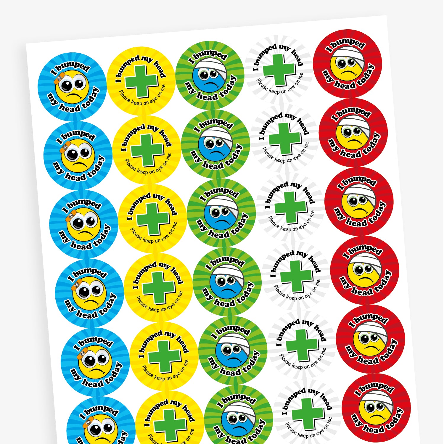Sheet of vibrant coloured circular stickers with two main designs.  A cartoon face with a plaster or bandage on the head has text surrounding the image saying 'I bumped my head today!'; the seconf is a central first aid cross with the words 'I bumped my head today.  Please keep an eye on me' sorrounding it