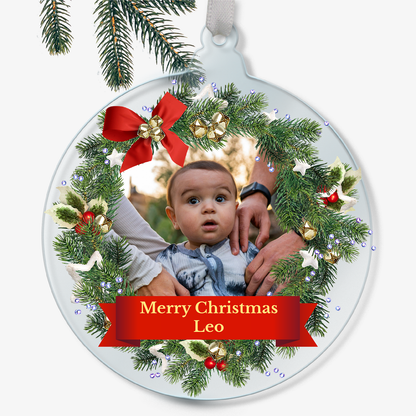 Personalised Christmas ornament with a child's photo and 'Merry Christmas Leo' text.