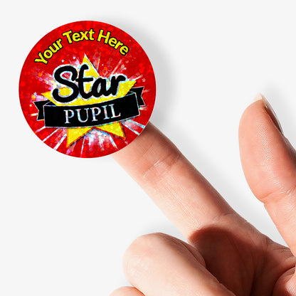 Red 'Star Pupil' sticker with customizable text held by a finger on a white background