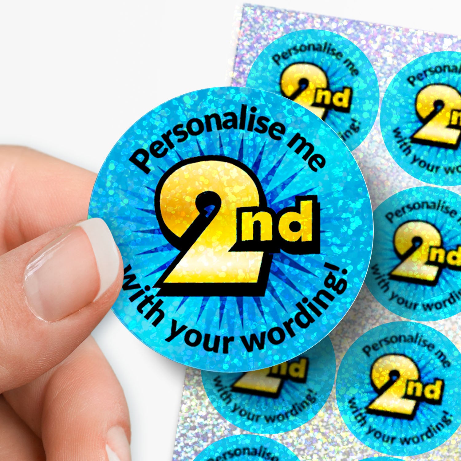 Round blue sticker with 'Personalise me 2nd' text held by a hand