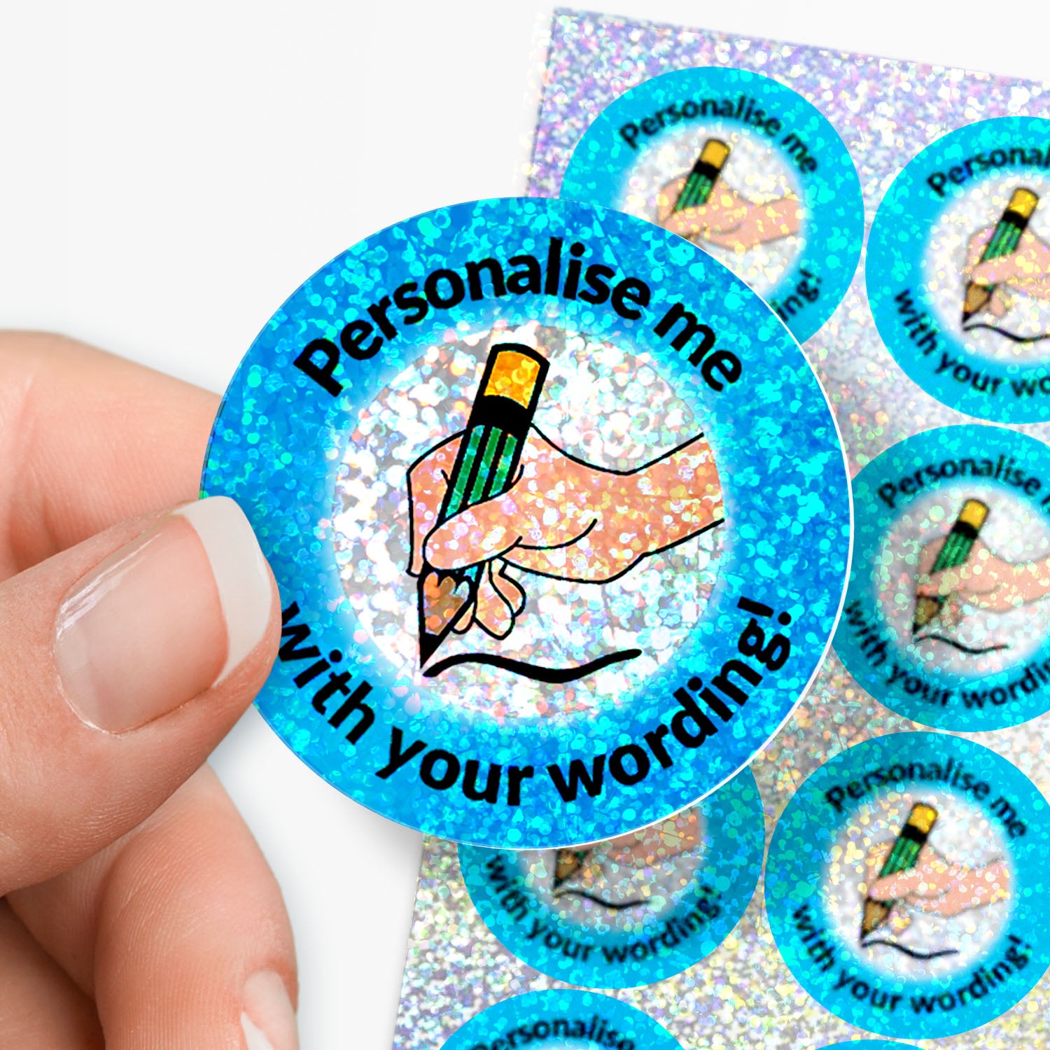 Circular stickers with a writing hand icon, personalised text, on a sparkly background held by hand.