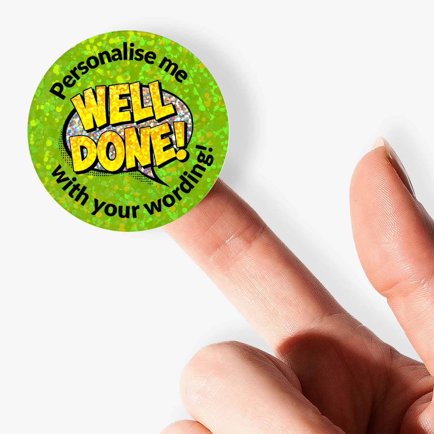 Round green sticker with 'Well Done!' text on a white background held in hand