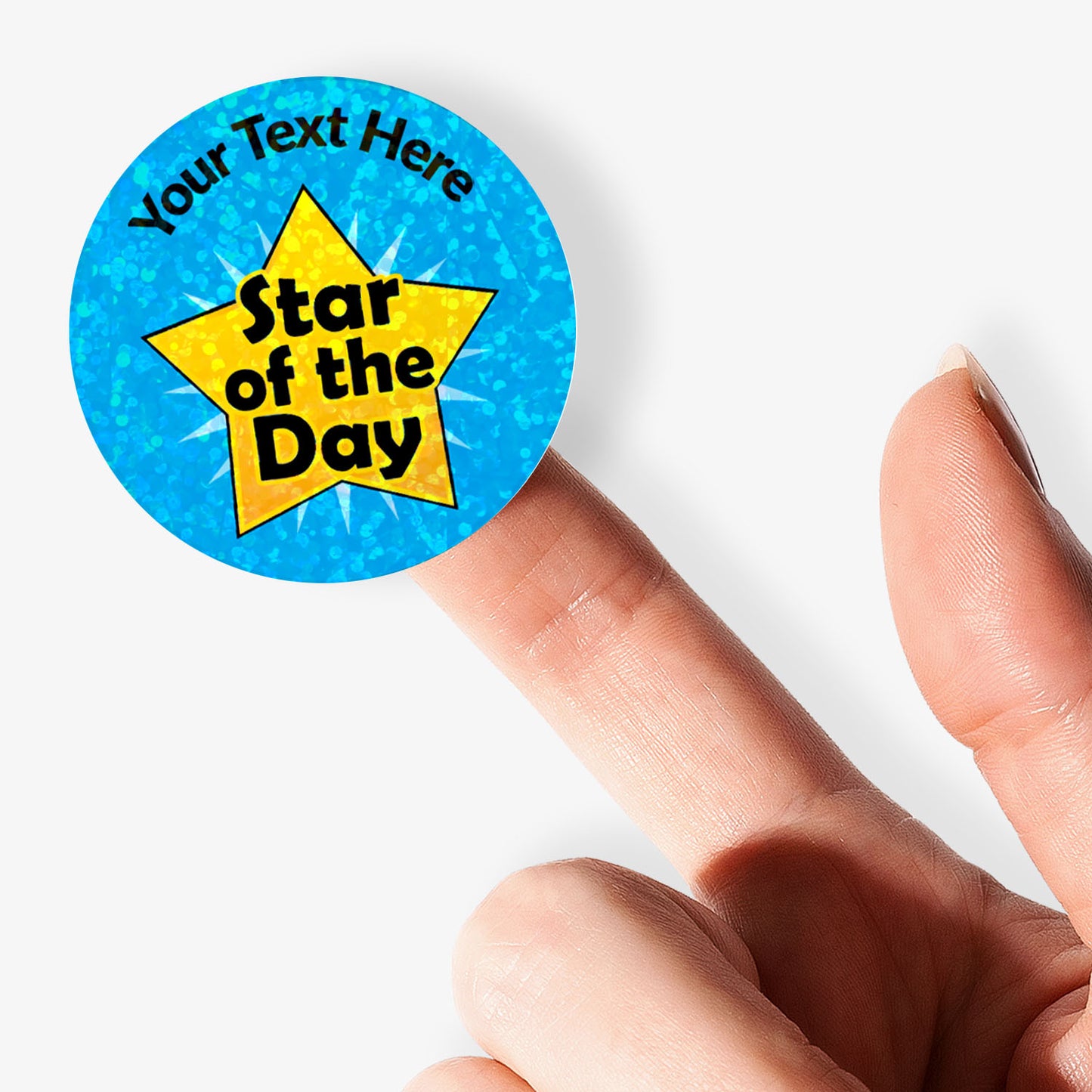 Personalised holographic sticker with 'Star of the Day' design on a blue background held by a hand.
