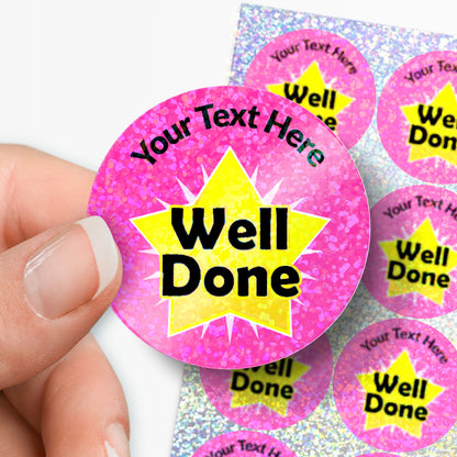 Personalised holographic pink 'Well Done' stickers with a hand holding one.