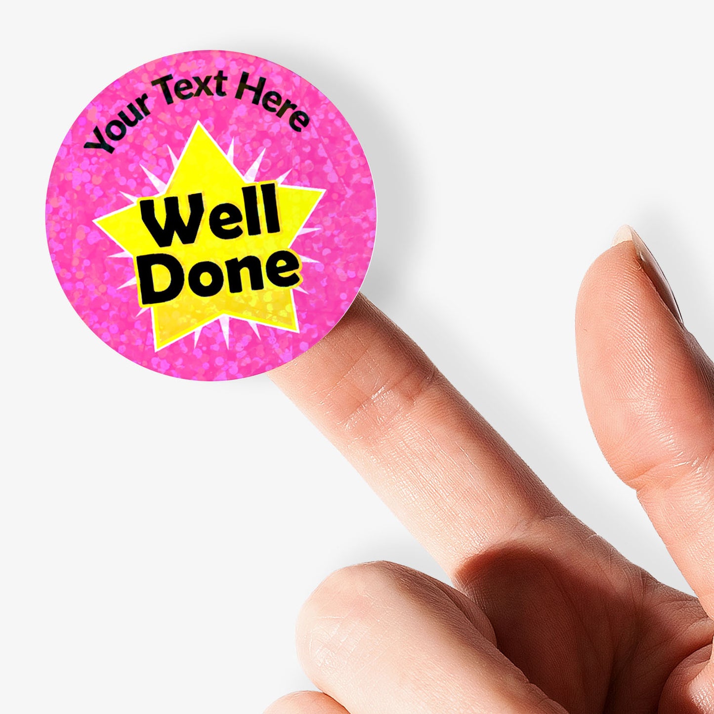 Pink personalised holographic sticker with 'Well Done' text held by a finger.