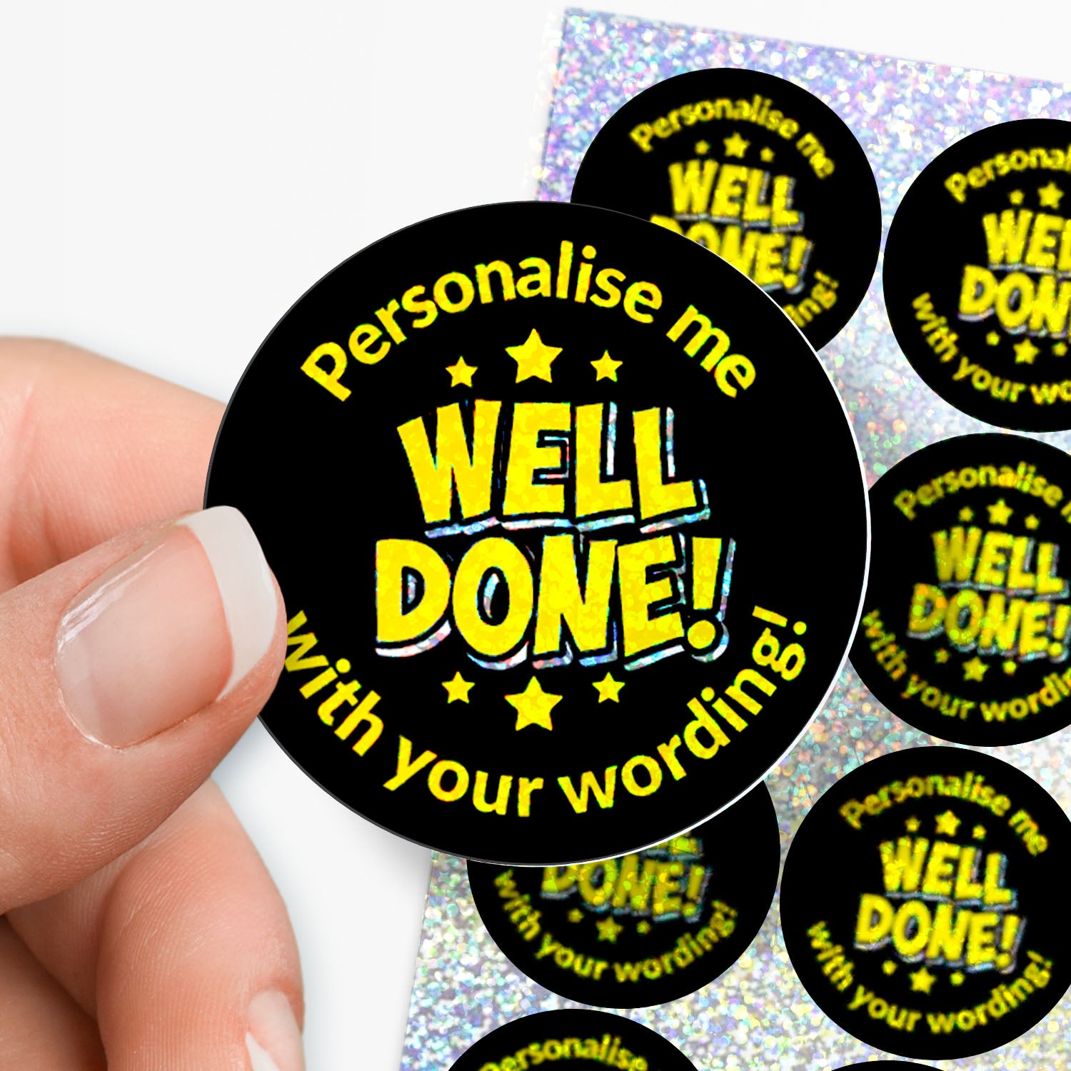 Personalised holographic round sticker with 'Personalise me WELL DONE! with your wording!' text held by a hand.