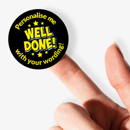 Personalised holographic round sticker with 'Well Done!' text held by a finger.