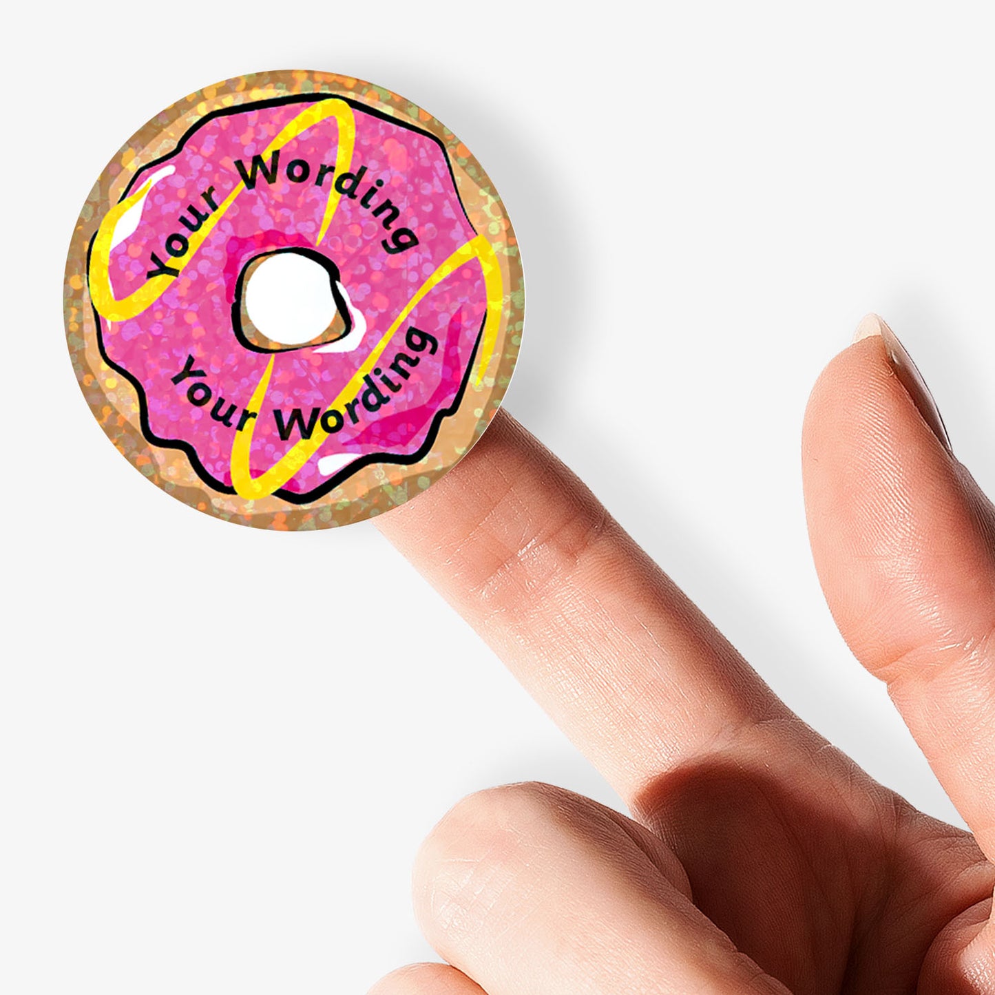 Pink donut-shaped object with 'Your Wording' text held by a finger on a white background