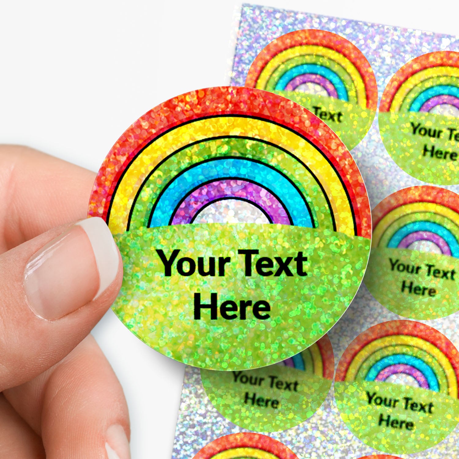 Colorful rainbow-themed stickers with 'Your Text Here' text held by a hand.