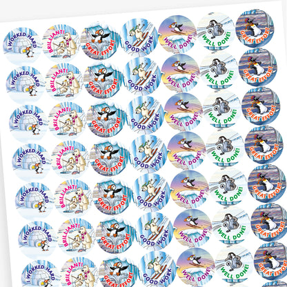 A sheet of circular reward stickers with phrases including 'I worked hard', 'Good Work', 'Well done' and 'Great Effort' in colourful text. Each sticker features arctic-themed cartoon animals such as puffins, polar bears, and walruses, engaging in playful activities against icy, snowy backdrops. 