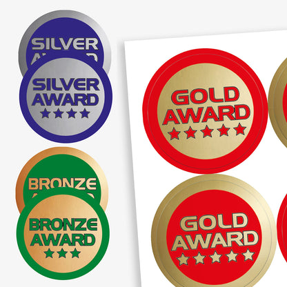 Collection of silver, gold, and bronze award stickers on a white background