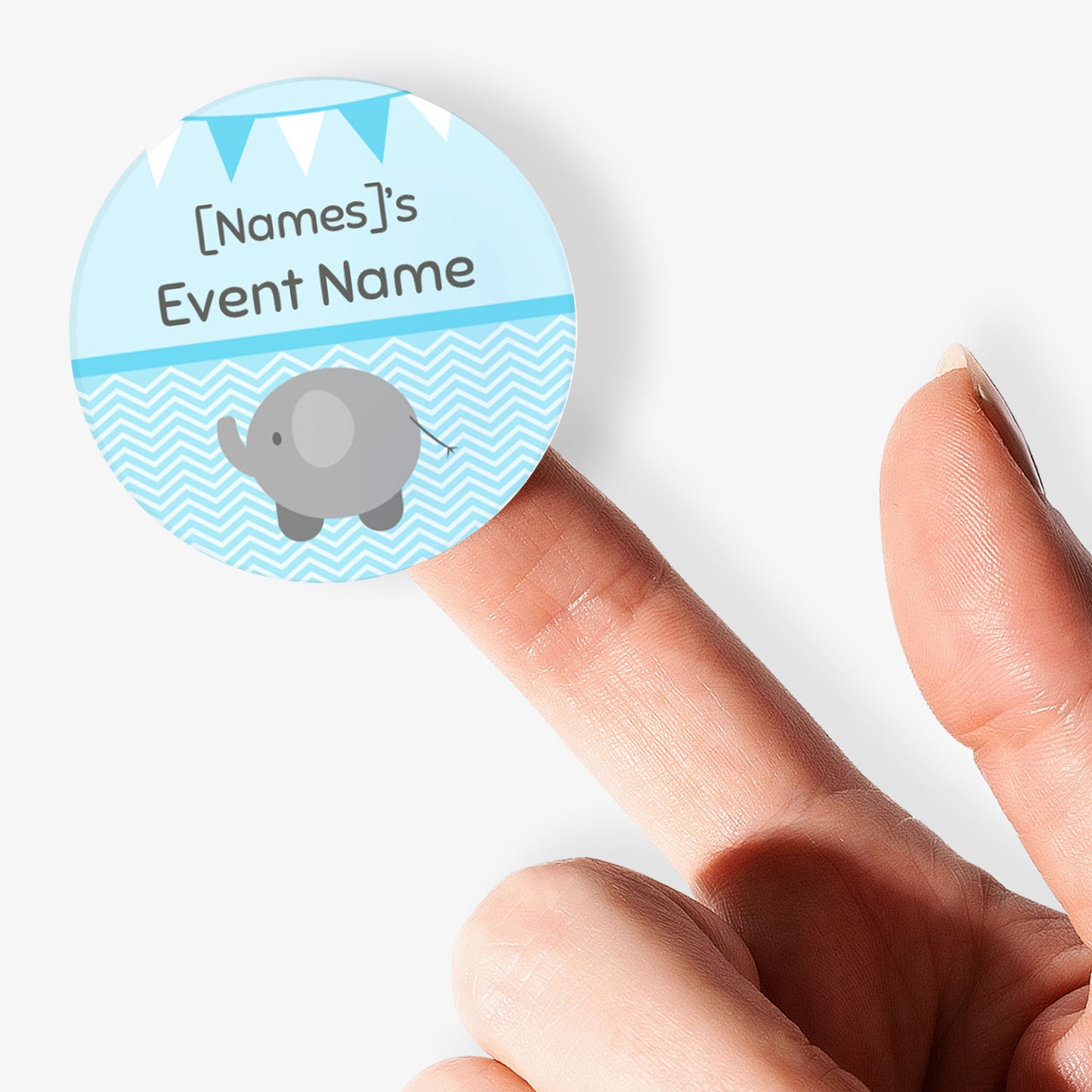 Blue circular sticker with an elephant and text being held by a finger