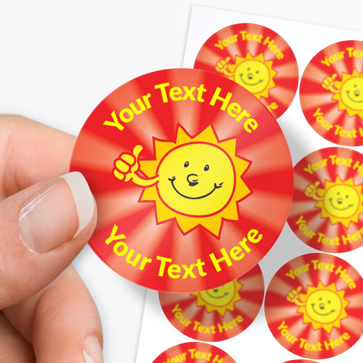 Red stickers with yellow sun design and 'Your Text Here' text held by a hand.