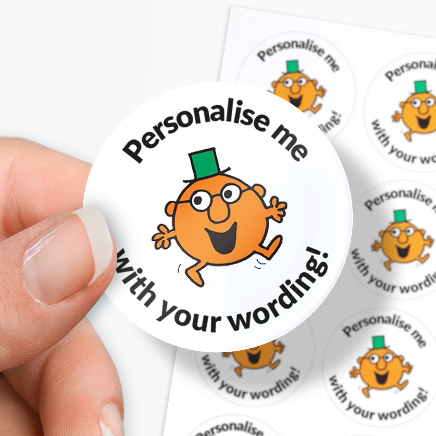 Circular sticker with a Mr Men character and text 'Personalise me with your wording!' held by a hand.