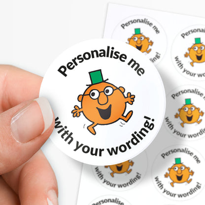 Circular sticker with a Mr Men character and text 'Personalise me with your wording!' held by a hand.