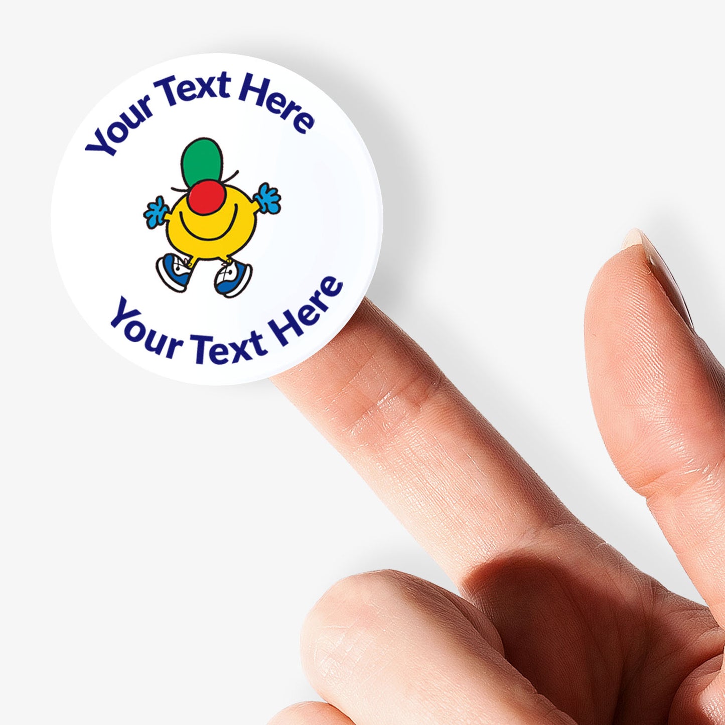 Personalisable sticker with a Mr Men character held by a finger on a white background.