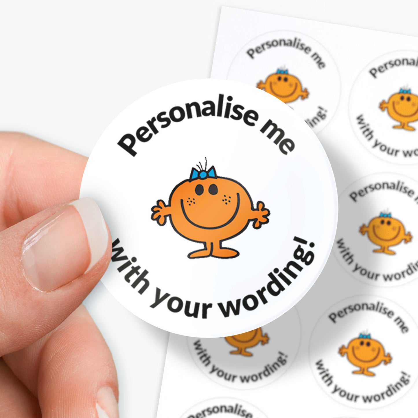 Circular sticker with a Little Miss character and text 'Personalise me with your wording!' held by a hand.